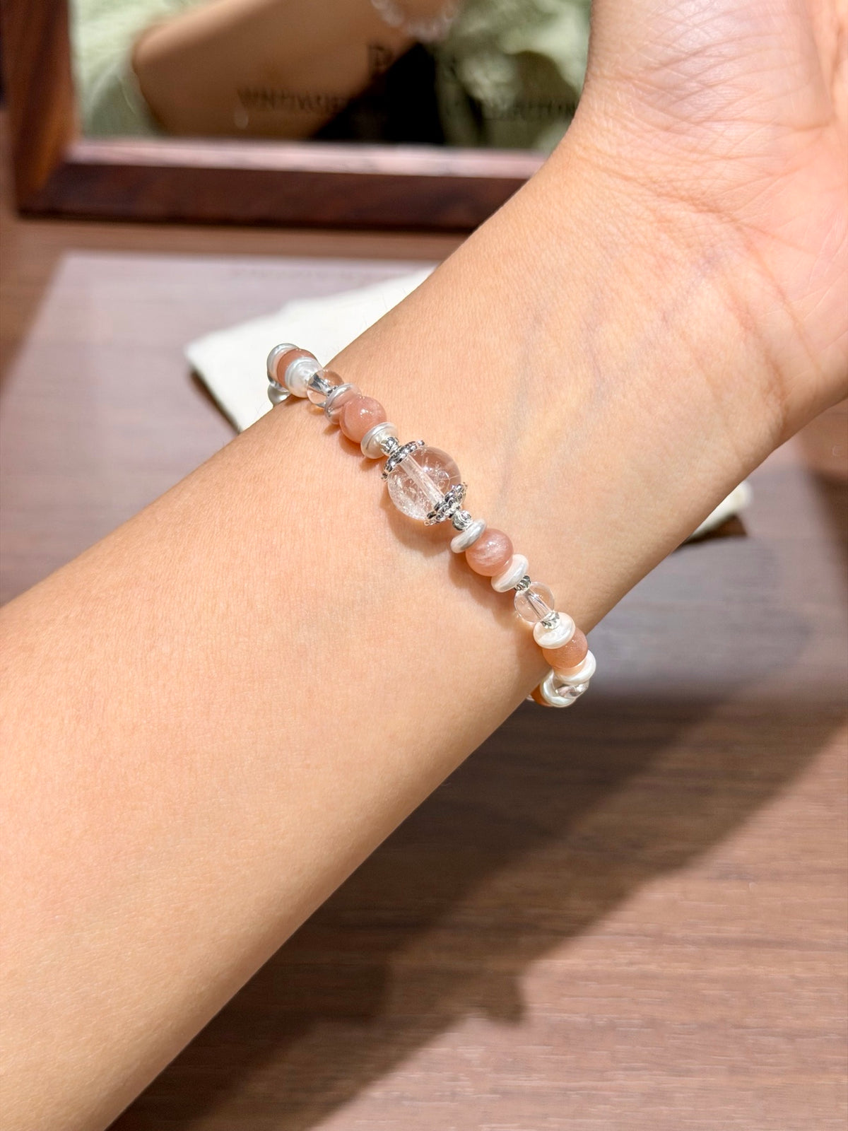 Warm glow orange moonstone bracelet worn on wrist